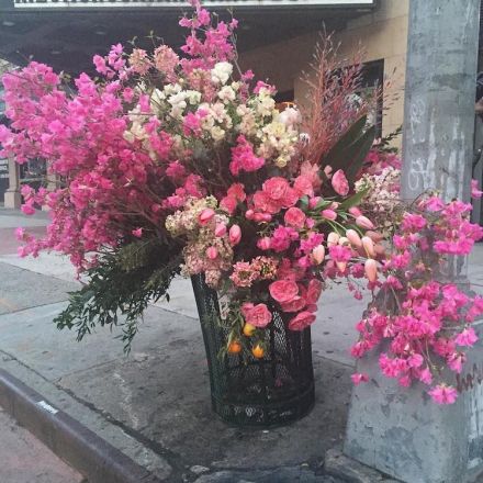 Floral designer is turning NYC trash cans into giant vases overflowing with flowers.