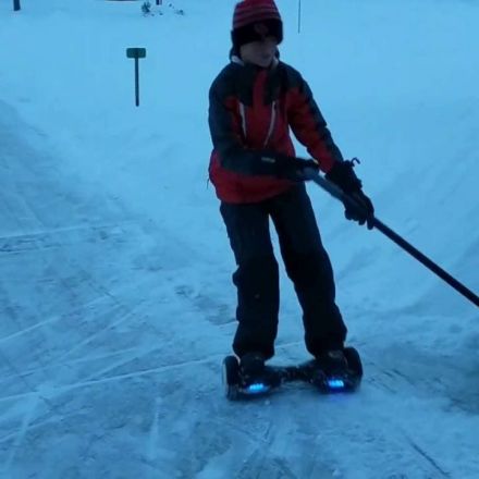 Kid uses his "hoverboard" to shovel snow