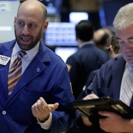 Dow spikes 322 points, closes above 26,000 for the first time