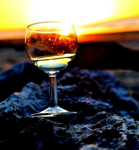 A wine glass at sunset at Ohiwa Beach