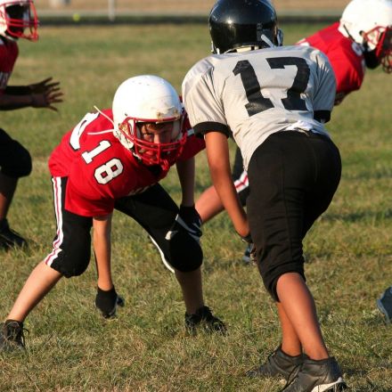 Americans love football, but differ on whether kids should play