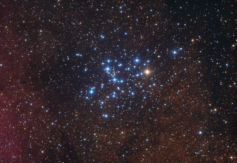 M6 is approximately 1600 light years distant. Most of the stars are hot, blue B type stars but the brightest of the group is an orange K type star, BM Scorpii, which is a semiregular variable. 