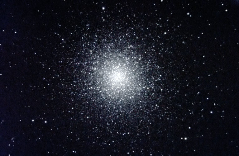 M13 contains hundreds of thousands of stars - red giants, blue stragglers, Sun-like stars, red and white dwarfs. It is about 25,000 l ight years away and about 12 billion years old.  (Photo by Bob Star)