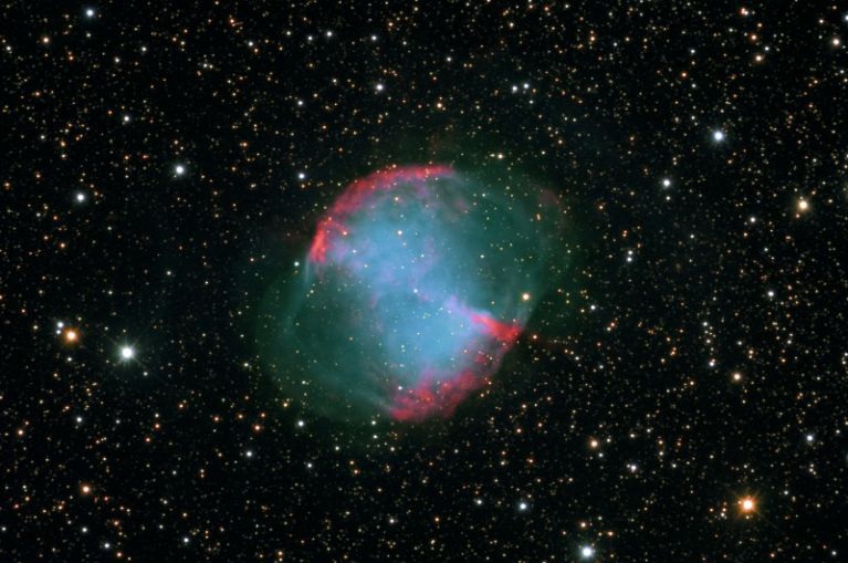 M27 was the first planetary nebula discovered. Messier found it and John Herschel christened it the Dumbbell Nebula. Age range estimates are all over the board, from 3-48,000 years old.  Distance is about 1200 light years. <br />
<br />
Image credit: www.mistisoftware.com/astronomy/<br />
