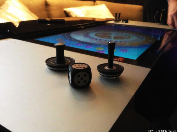 With the computer, you also get a set of sliding air hockey paddles, a set of joysticks, and even a large six-sided die.