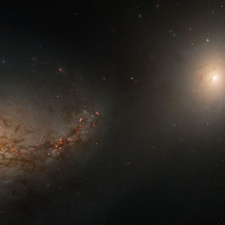 Hubble telescope sees haunting galactic dance of 2 galaxies linked by the corpse of a cannibalized neighbor